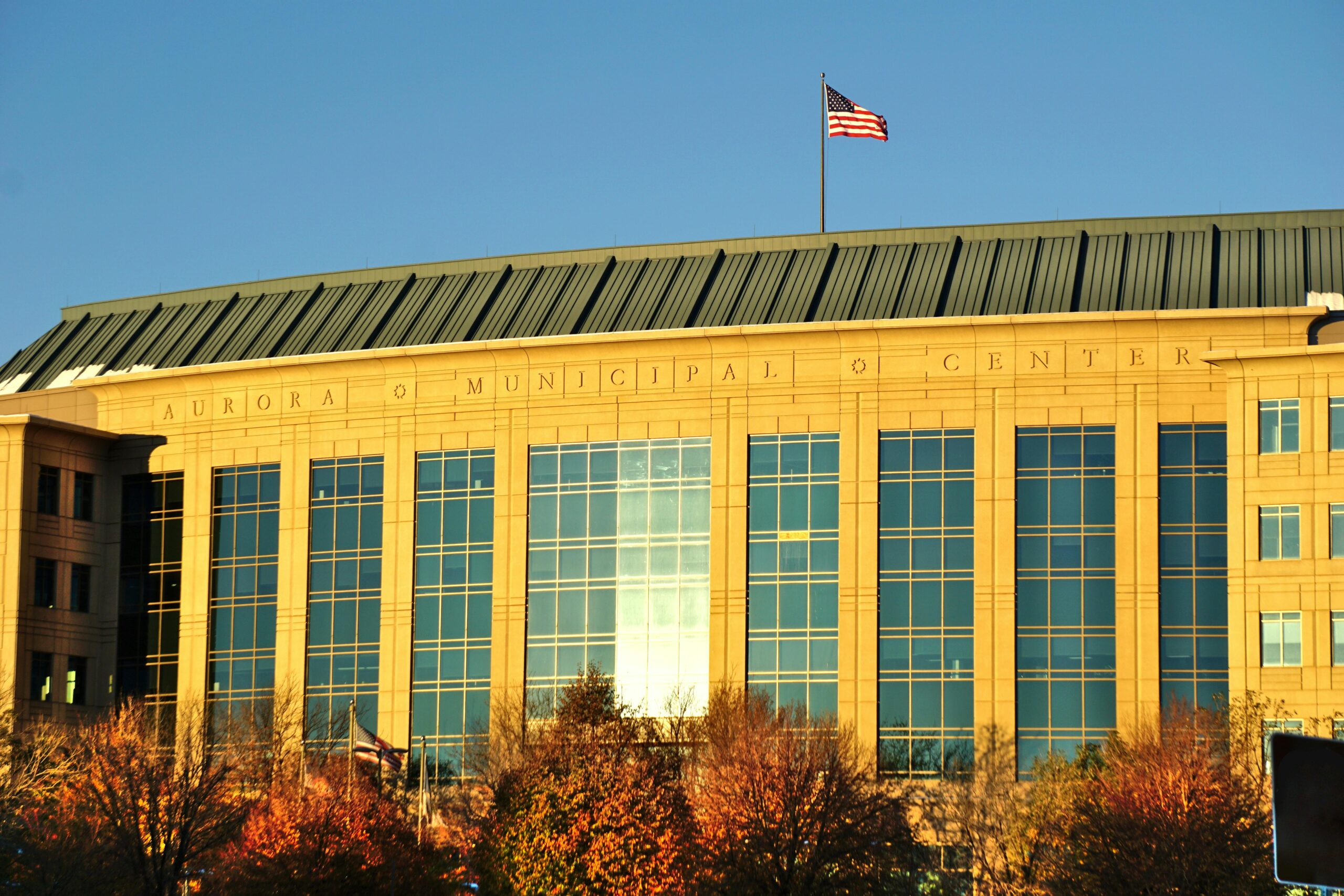 Aurora Municipal Center building with American flag flying above